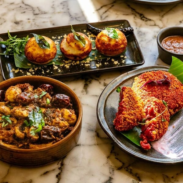 Three plates of Indian cuisine, including fried patties, a mushroom dish, and small round appetizers.